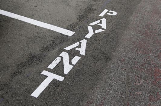 Sign of payment on the asphalt, detail of sign of imformation