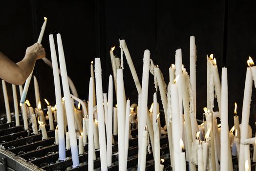 Candles lit, detail of old lighting element
