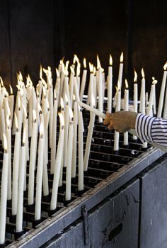 Candles lit, detail of old lighting element