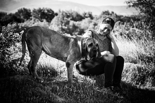 Woman with dog in nature, friends enjoying in the field