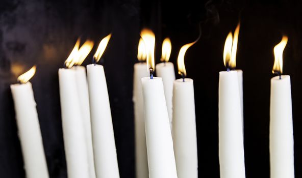 Candles lit, detail of old lighting element
