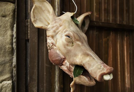 Head of dead pig, detail of pork in a butcher shop, fat meal