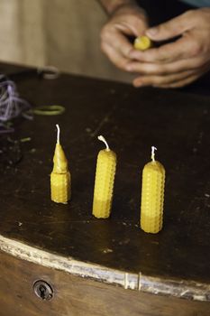 Artisan expert making beeswax candles, detail of old craft