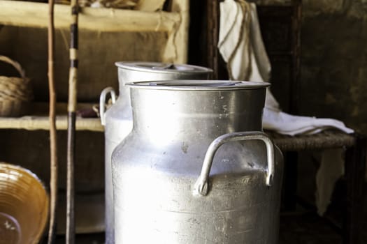 Antique metal containers for milk, detail of objects on a farm