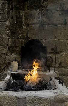 Carbon fire in a forge, detail of a workshop with iron
