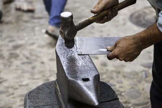 Old hammer and anvil on a forge, detail of old tool