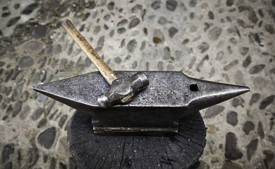 Old hammer and anvil on a forge, detail of old tool