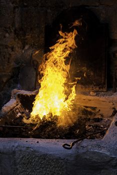 Carbon fire in a forge, detail of a workshop with iron