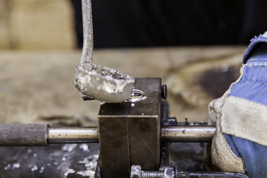 Detail of metal cast to the heat, detail of handling and molding of metal