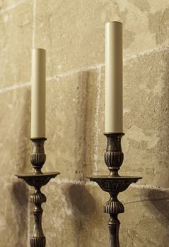 Old medieval candelabrum with wax candles, detail of lighting instrument