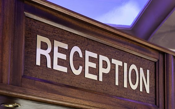Old sign of reception in a hotel, detail of information for tourists