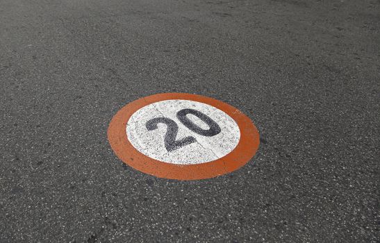 Speed limit sign on asphalt, detail of obligation