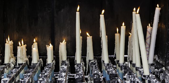 Wax candles burning in a Christian tradition, flame and faith