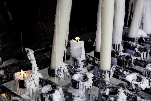 Wax candles burning in a Christian tradition, flame and faith