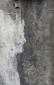 Old concrete wall damaged by time, detail of ruin and abandonment in the city