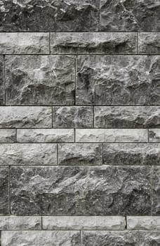 Wall decorated with natural stones, detail of a textured background
