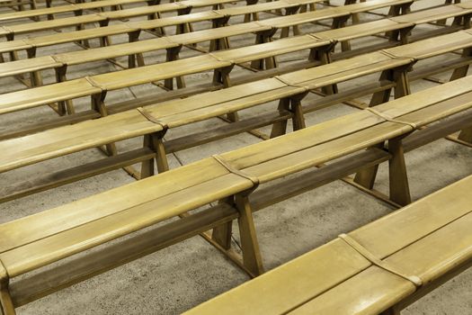 Old wooden benches in a church, detail of place to sit and pray