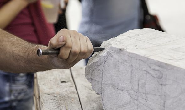 Carving stone, craftsman shaping stone, art and crafts