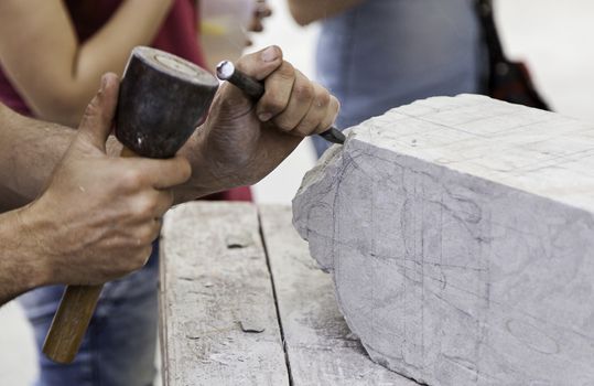 Carving stone, craftsman shaping stone, art and crafts