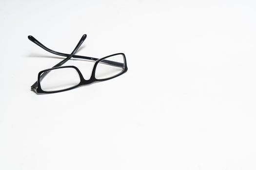 a pair of glasses on a white surface