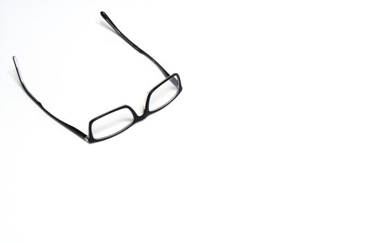 a pair of glasses on a white surface