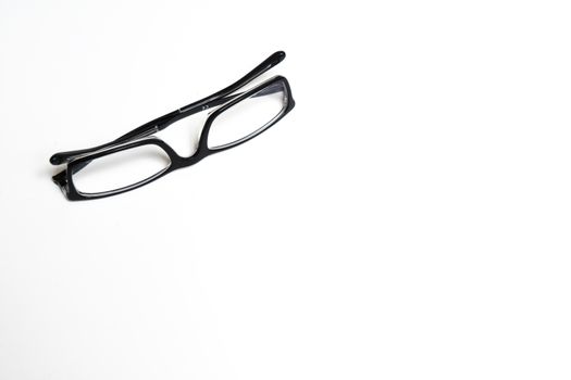 a pair of glasses on a white surface