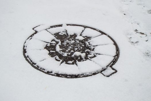 Hatch cover municipal waste water covered with first snow