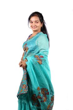 A beautiful Indian woman in a traditional saree, on a white studio background.