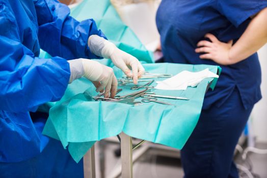 nurse preparing medical instruments for operation