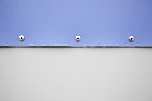 Plastic wall with screws, detail of a wall on the outside, wet