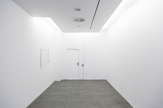 Long walkway and white wall, detail of a hospital corridor