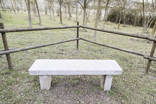 Stone bench in a park, detail of a place to rest