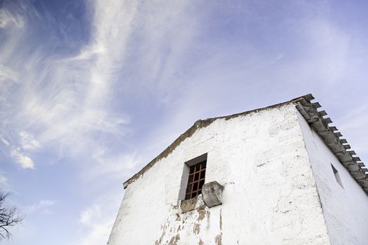 Old abandoned house, detail of an old house with sky