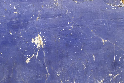 Cement wall painted blue, detail of a wall decorated