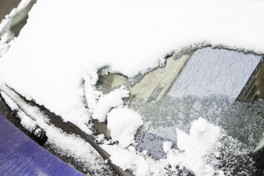 Snow covered car in winter, snow on a winter day in the city, cold