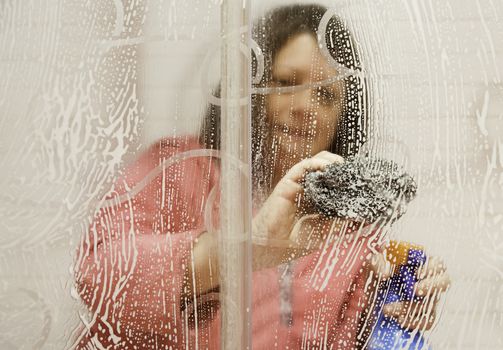 Girl cleaning the bathroom, detail of woman cleaning a shower, cleaning and hygiene