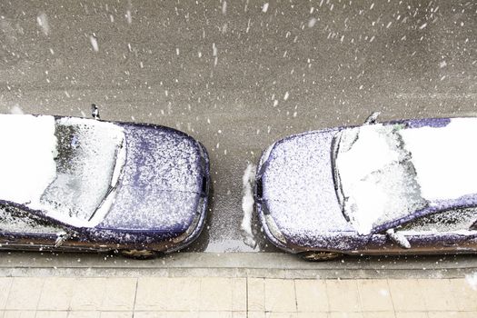Snow covered car in winter, snow on a winter day in the city, cold
