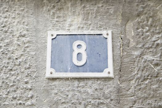 Number eight on the wall of a house, detail of a number of information, even number