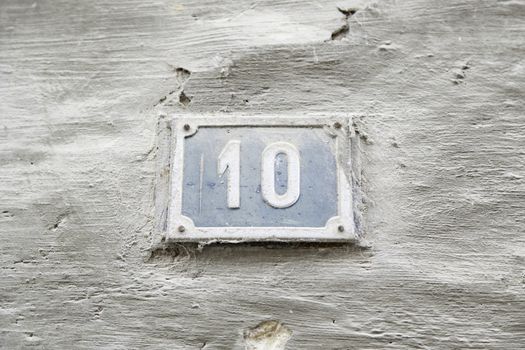 Number ten on the wall of a house, detail of a number of information, even number