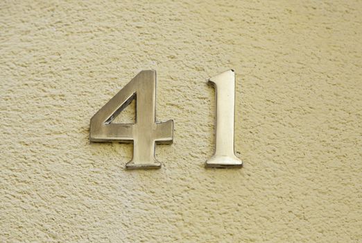 Number forty-one on the wall of a house, detail of an odd number