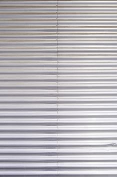 Bright metal background, detail of a textured steel