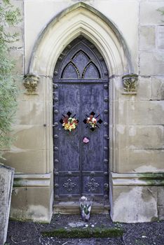 Old gate of a funeral pantheon, detail of edification for dead, graveyard