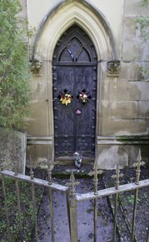 Old gate of a funeral pantheon, detail of edification for dead, graveyard