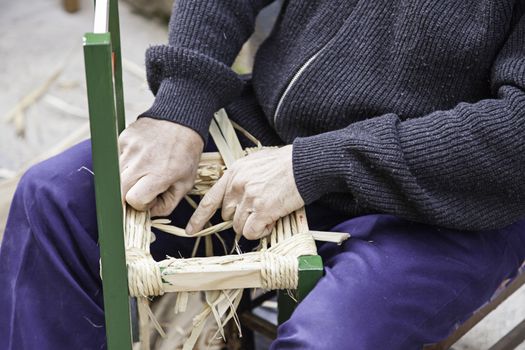 Craftsman wicker person working with his hands, arts and crafts