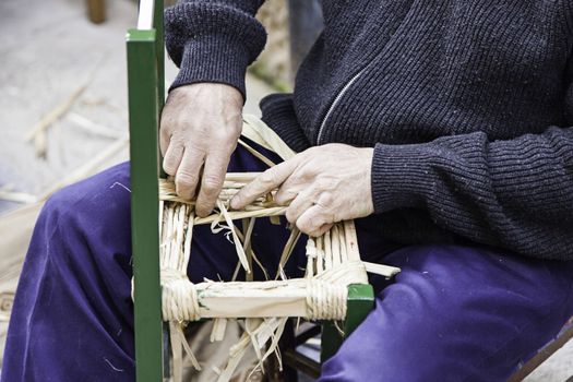 Craftsman wicker person working with his hands, arts and crafts