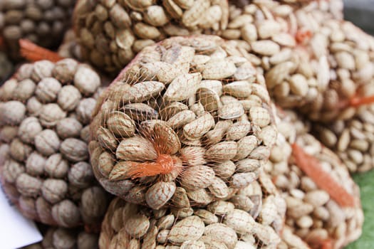 Raw almonds in shell, detail of a traditional market