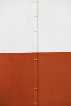 White wall with a pipe, detail of a textured wall
