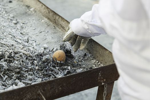 Eggs in a charcoal grilling, detail of how to cook some eggs, feed and food