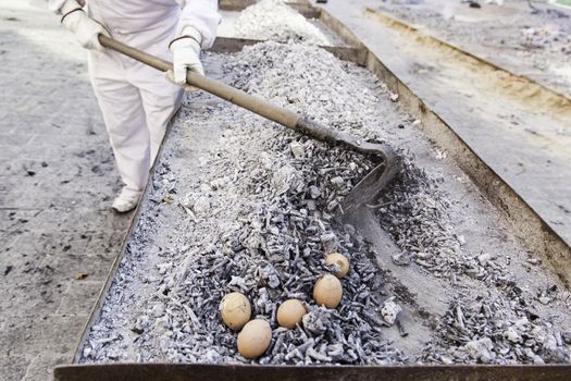 Eggs in a charcoal grilling, detail of how to cook some eggs, feed and food