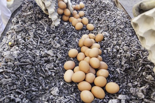 Eggs in a charcoal grilling, detail of how to cook some eggs, feed and food